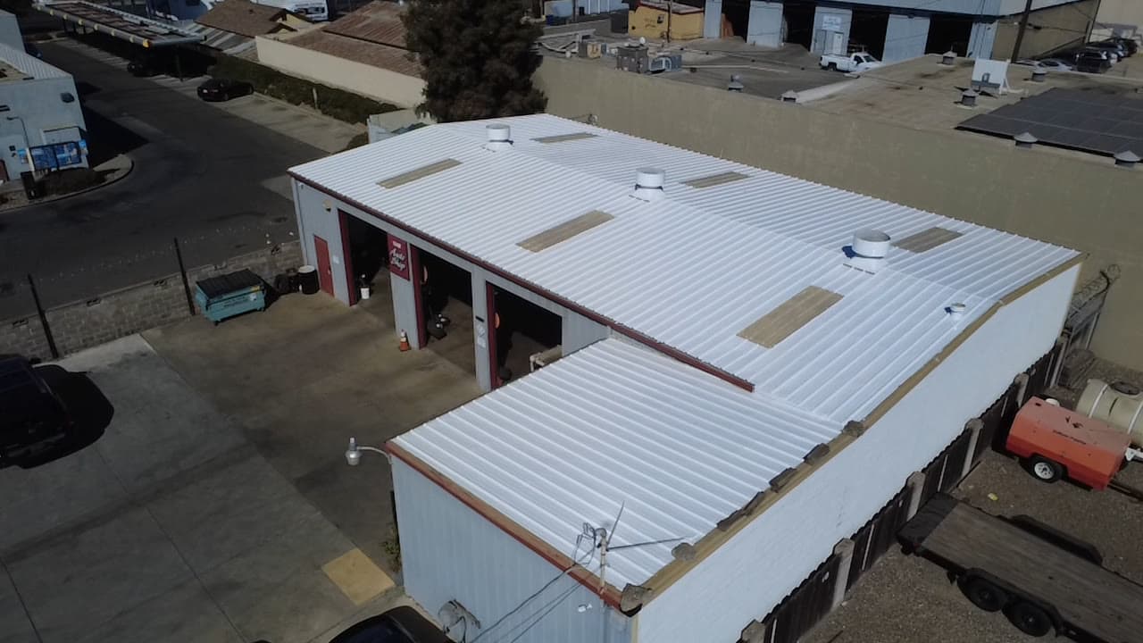 Closer aerial of the coated roof, skylights and vents